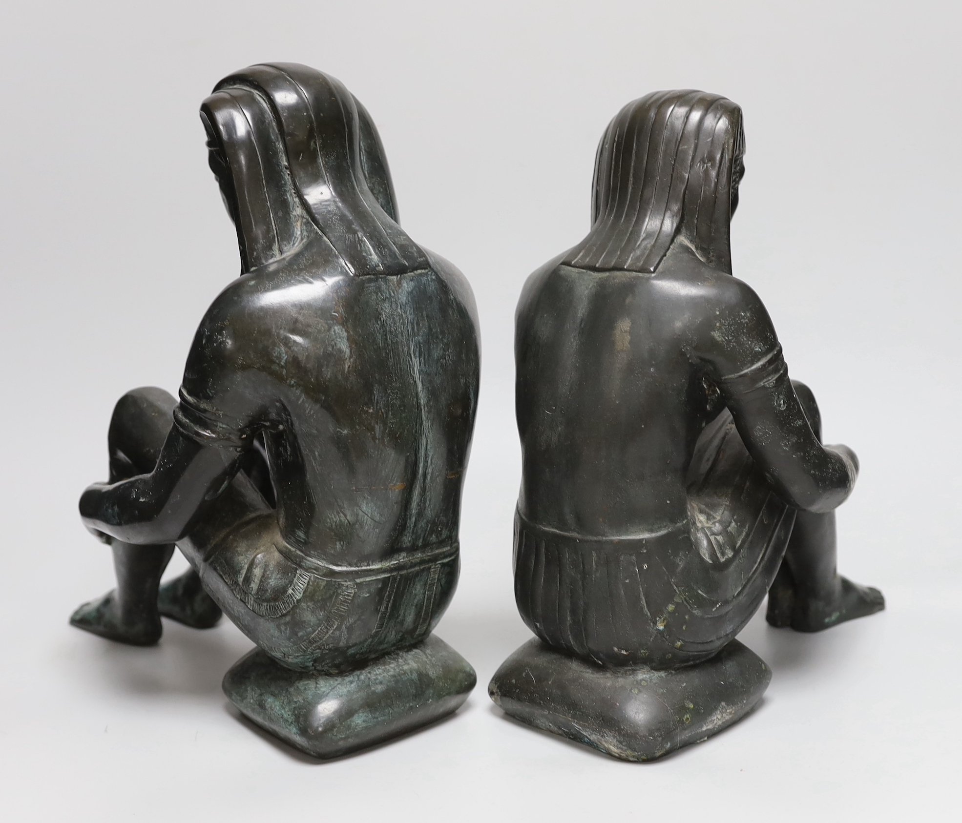 A pair of cast bronze seated Egyptian figures wearing headdresses, the largest 30cm high